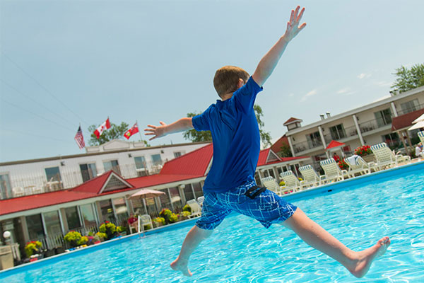 Image of a kid jumping in the pool