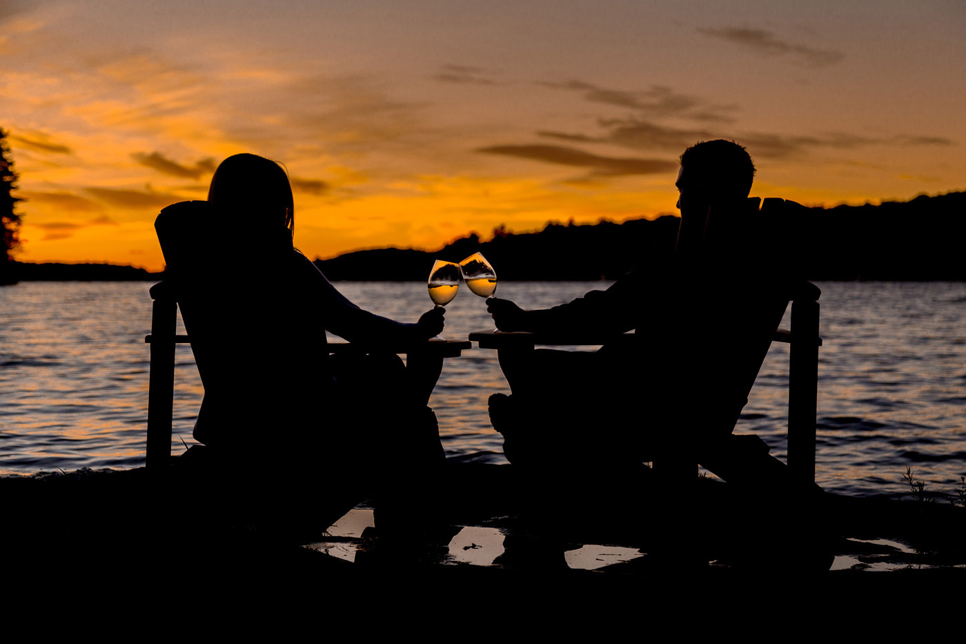 Image of a couple having a glass of wine on the dock