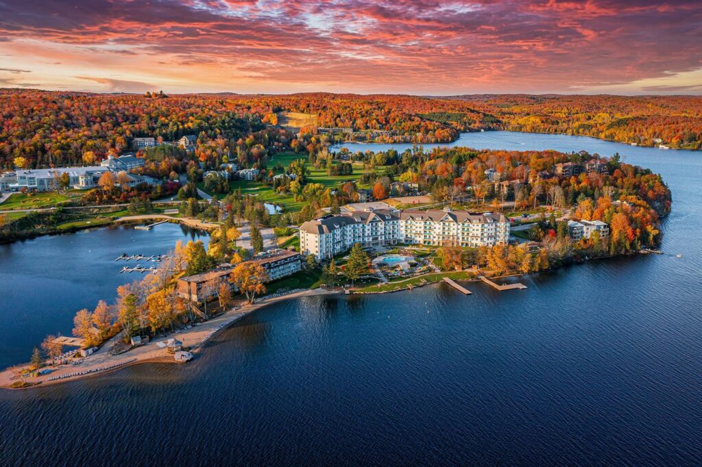 Aerial image of Deerhurst Resort with the fall colours popping - Resorts of Ontario