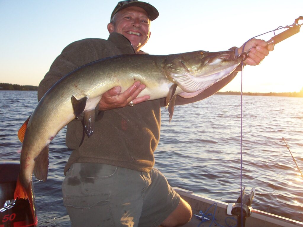 Man holding a big fish he caught at Pine Vista Resort - Resorts of Ontario