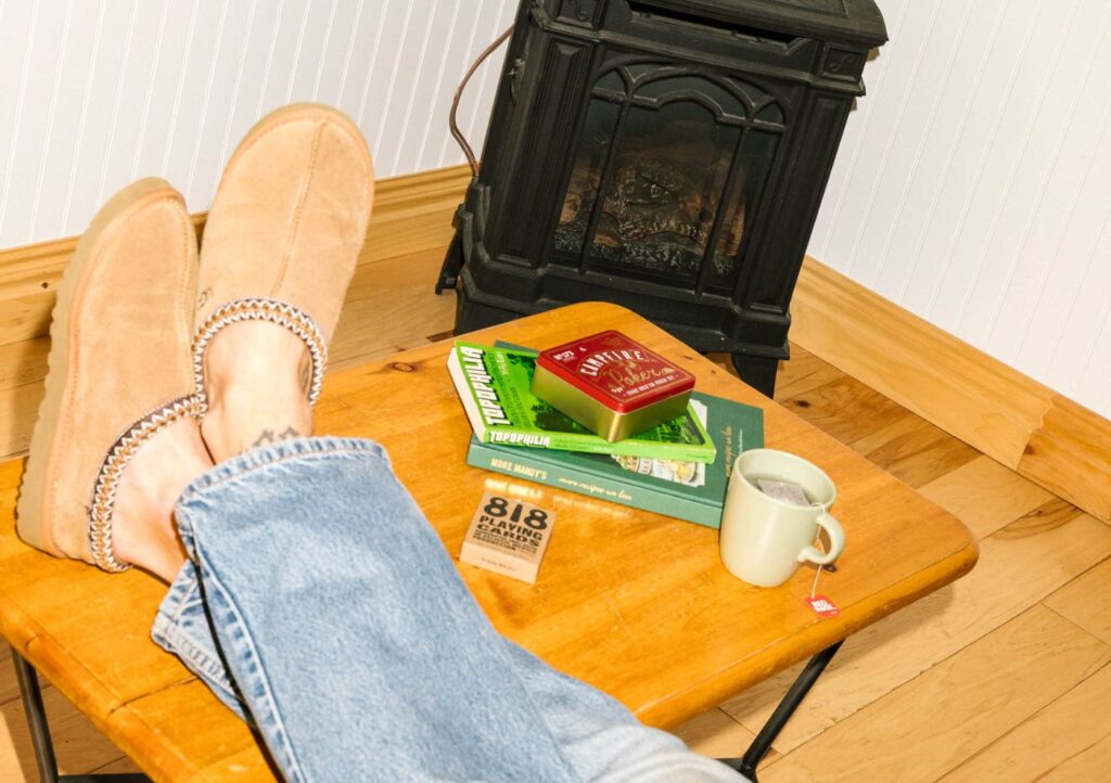 image of someone that has their feet up on a table inside a cottage at Elmhirst's Resort - Resorts of Ontario