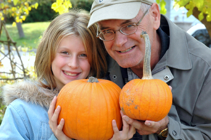 Image of a grandfather and granddaughter holding pumpkins at Pine Vista Resort - Resorts of Ontario