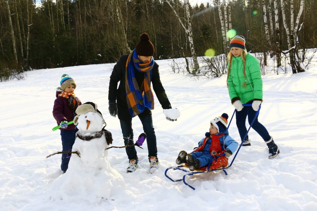 Image of a family playing in the snow at Bayview Wildwood Resort - Resorts of Ontario