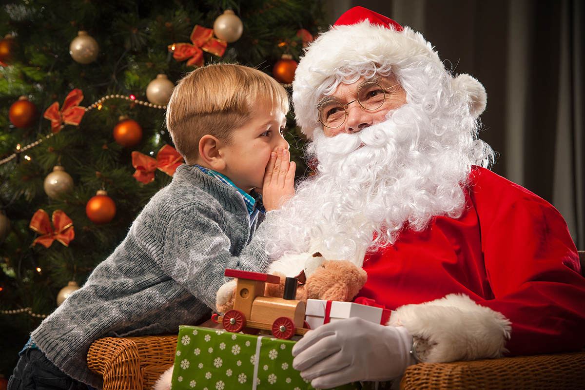 Stock image of a kid talking to Santa - Resorts of Ontario