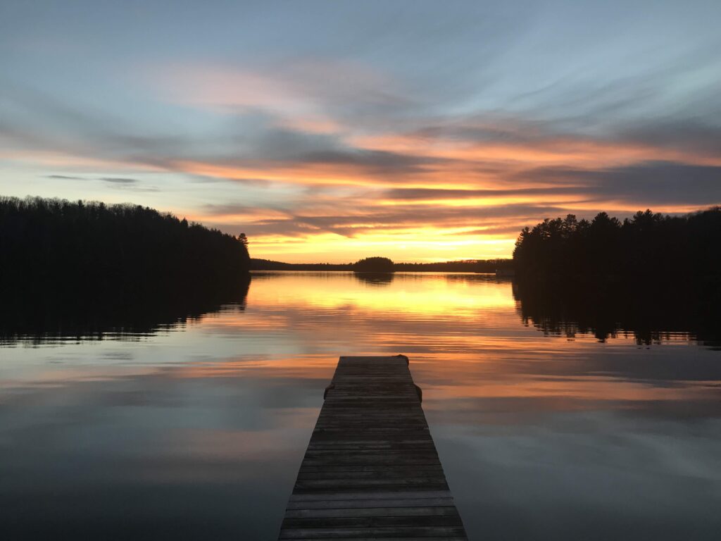 Image of a sunset from a Canoe at Bondi Resort - Resorts of Ontario