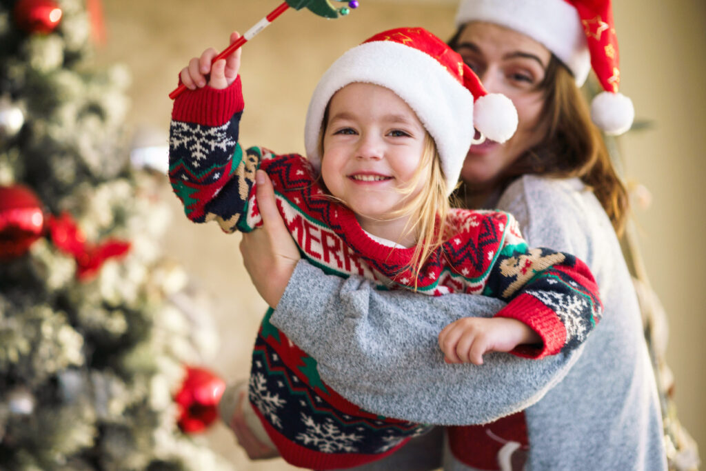 Mother and daughter around a Christmas tree at Nottawasaga Resort - Resorts of Ontario