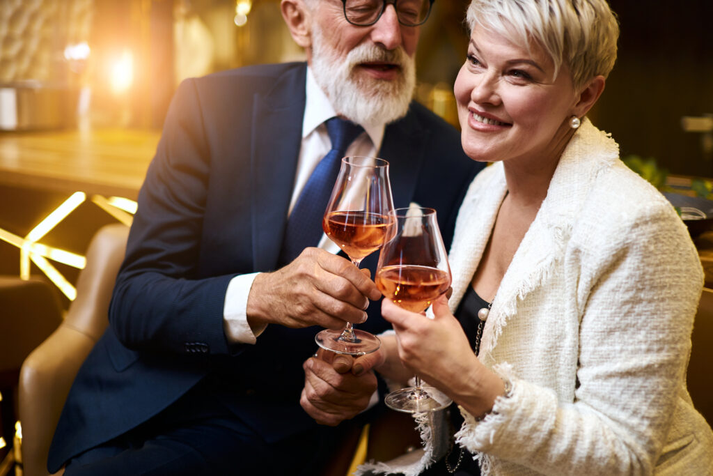 Image of an older couple celebrating New Years with drinks at Nottawasaga Resort - Resorts of Ontario