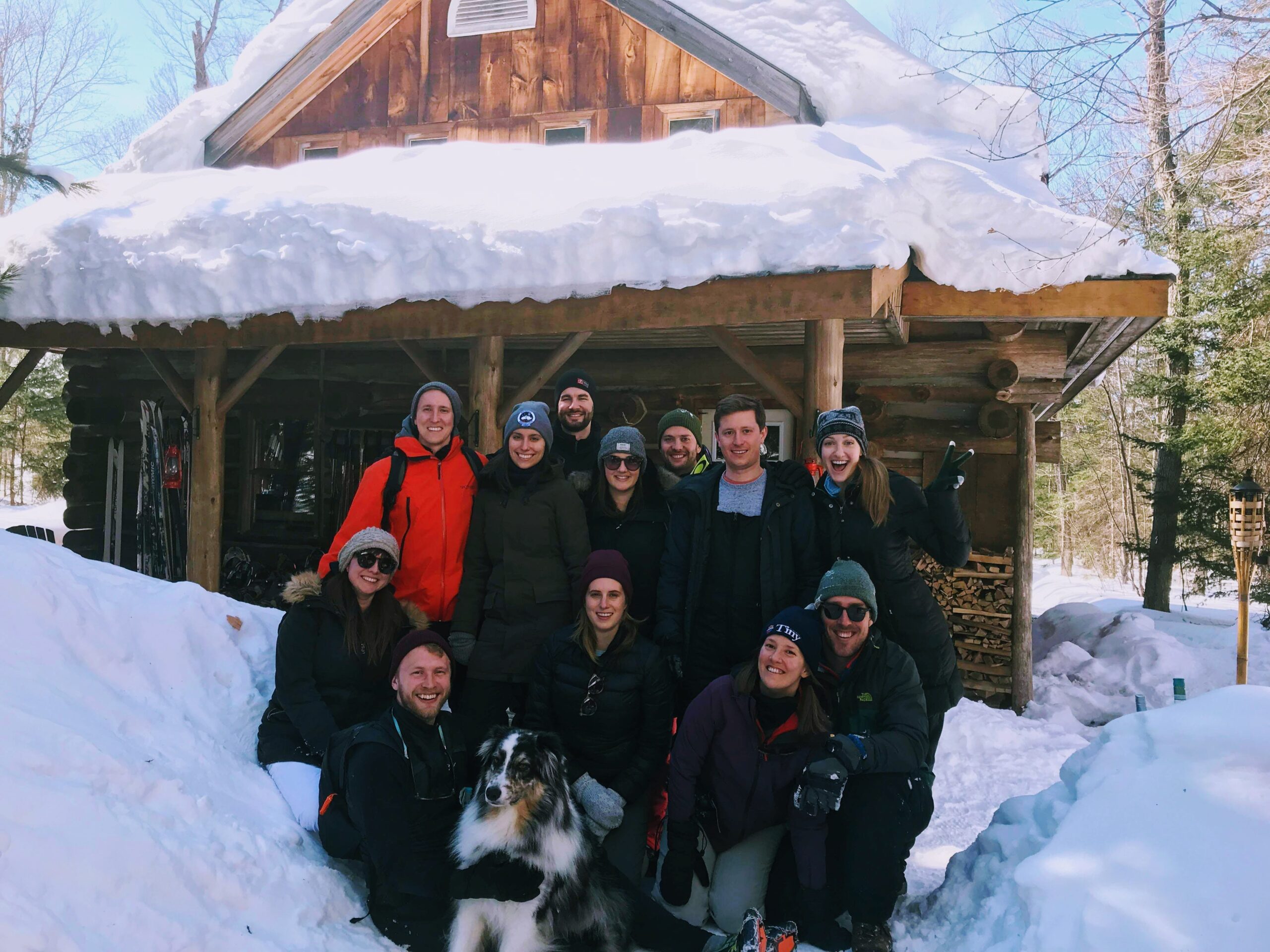 Image of a family outside a log cabin at Algonquin Log Cabin and Cottage Outpost - Resorts of Ontario