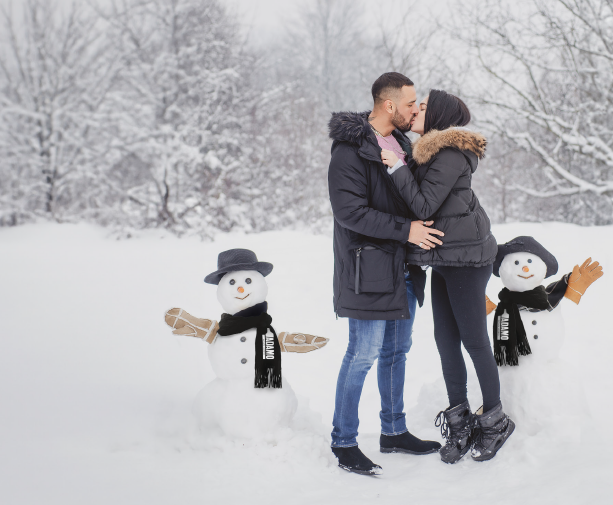 Couple with a snowman - Resorts of Ontario